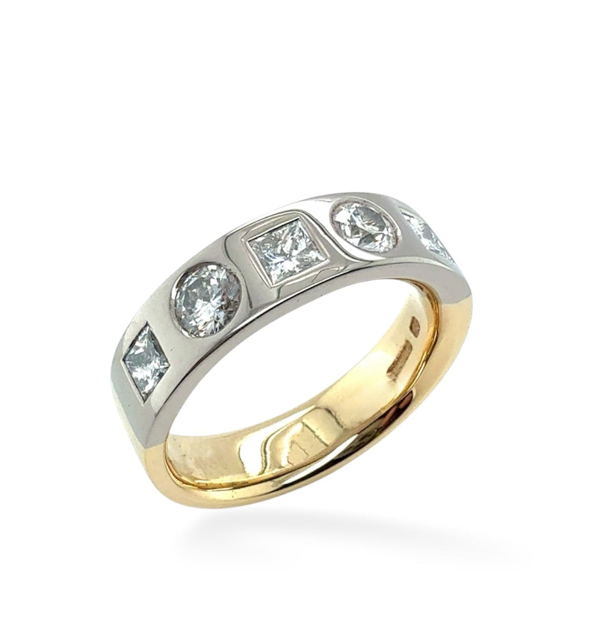 A two-tone yellow gold and white gold ring featuring a row of clear square and round-cut gemstones on the band, set against a plain white background.