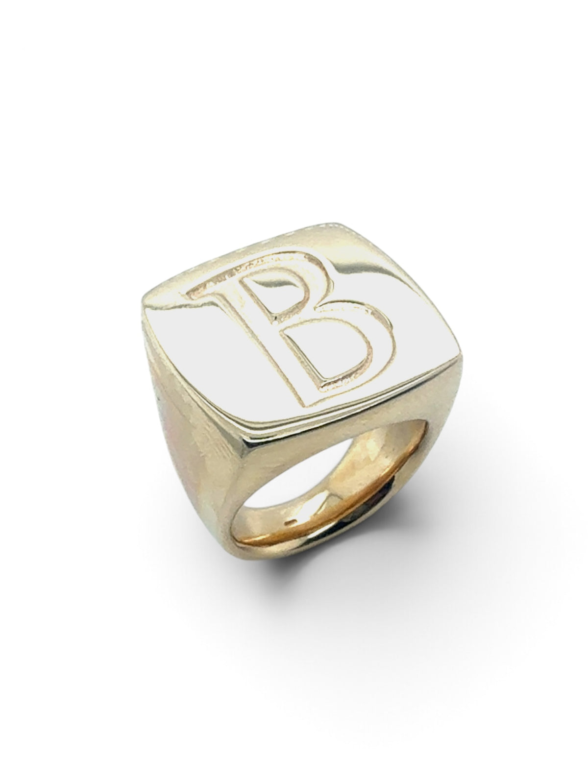 A gold signet ring with a square face featuring an engraved capital letter 'B', shown on a clean white background.