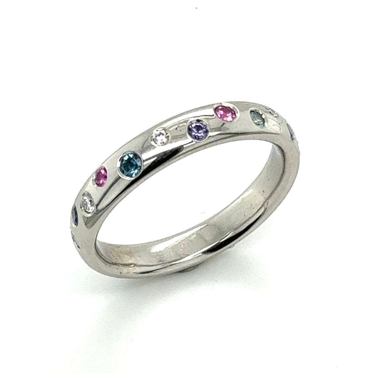 Platinum eternity ring set with a scatter of sapphires and diamonds 