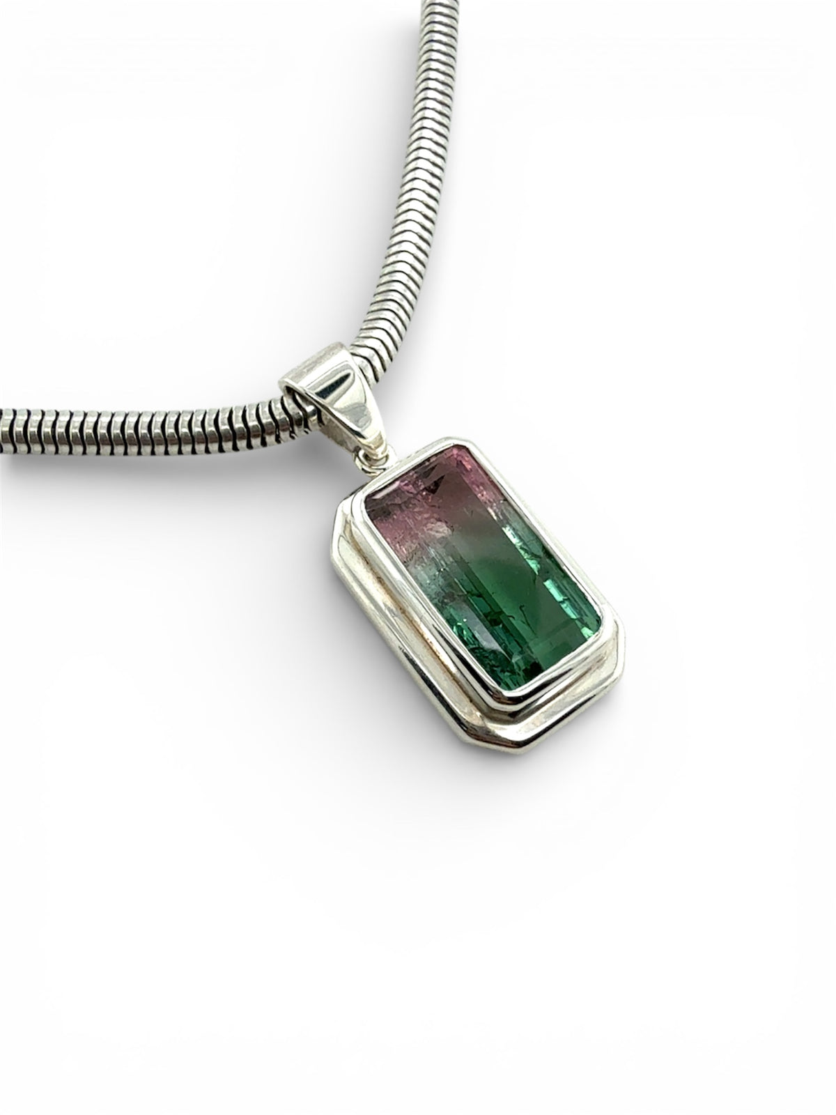 Necklace with a watermelon Tourmaline rectangular gemstone pendant in a simple silver setting on a white background